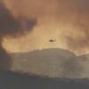 A fire-fighting helicopter approaches an out of control fire in the Bunyip State Park.